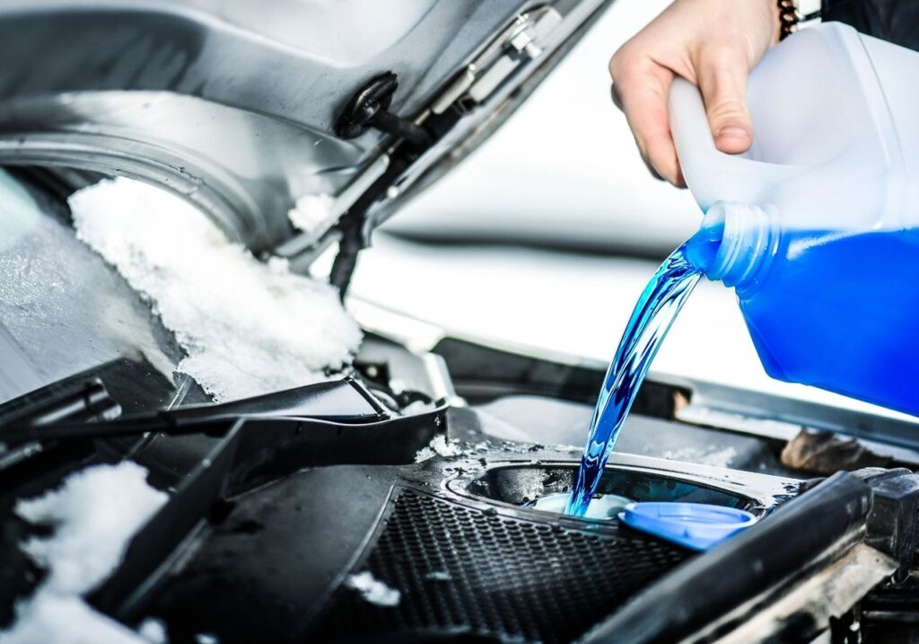image of pouring a winterization fluid