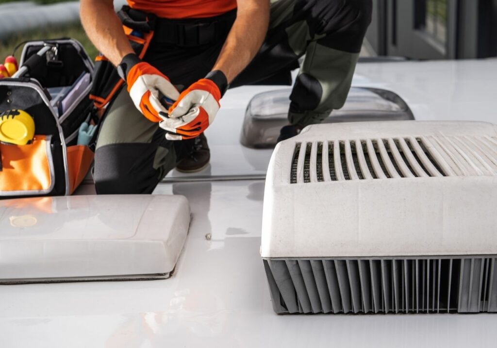 RV technician fixing an rv AC
